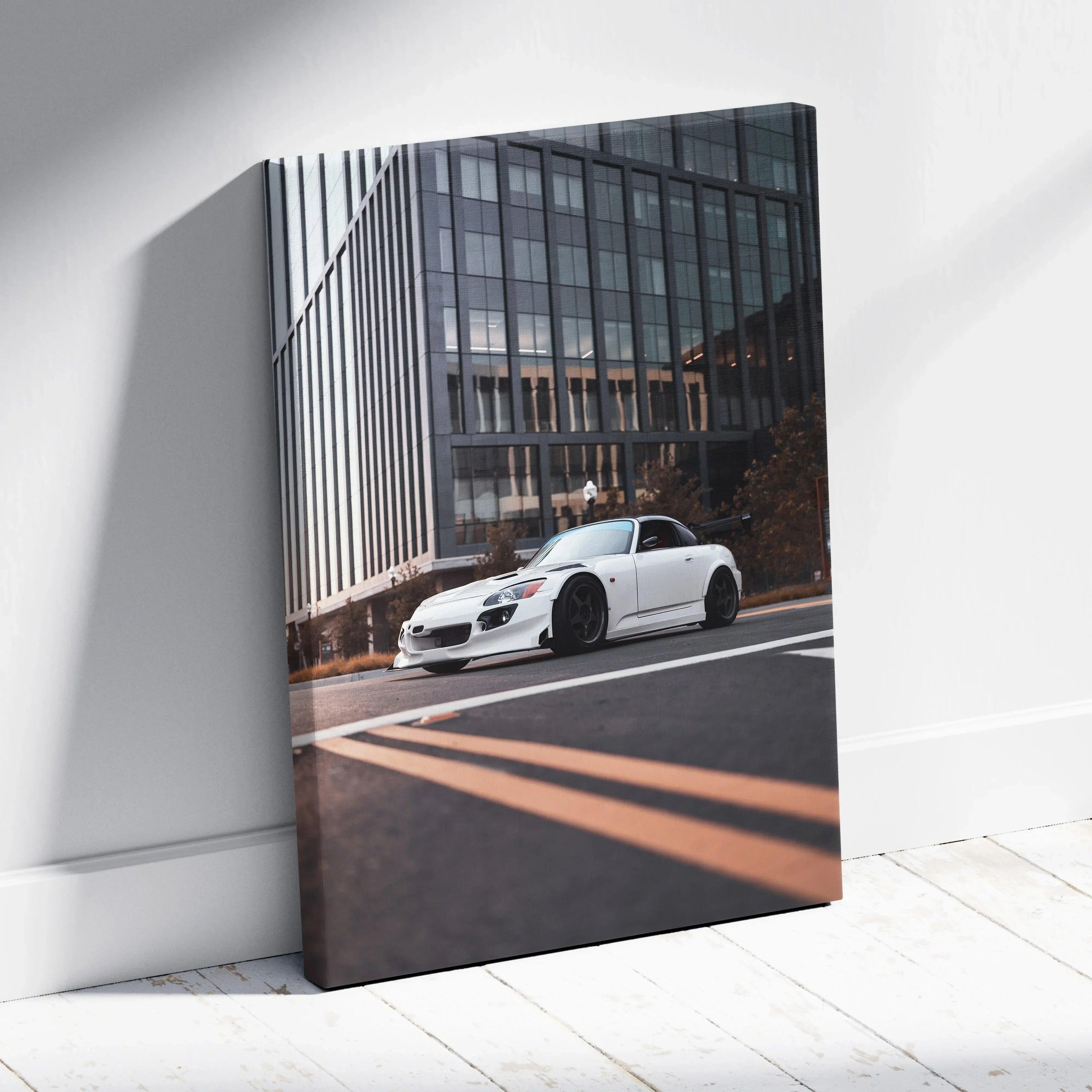 White Honda S2000 sports car on city street canvas wall art with modern building background.