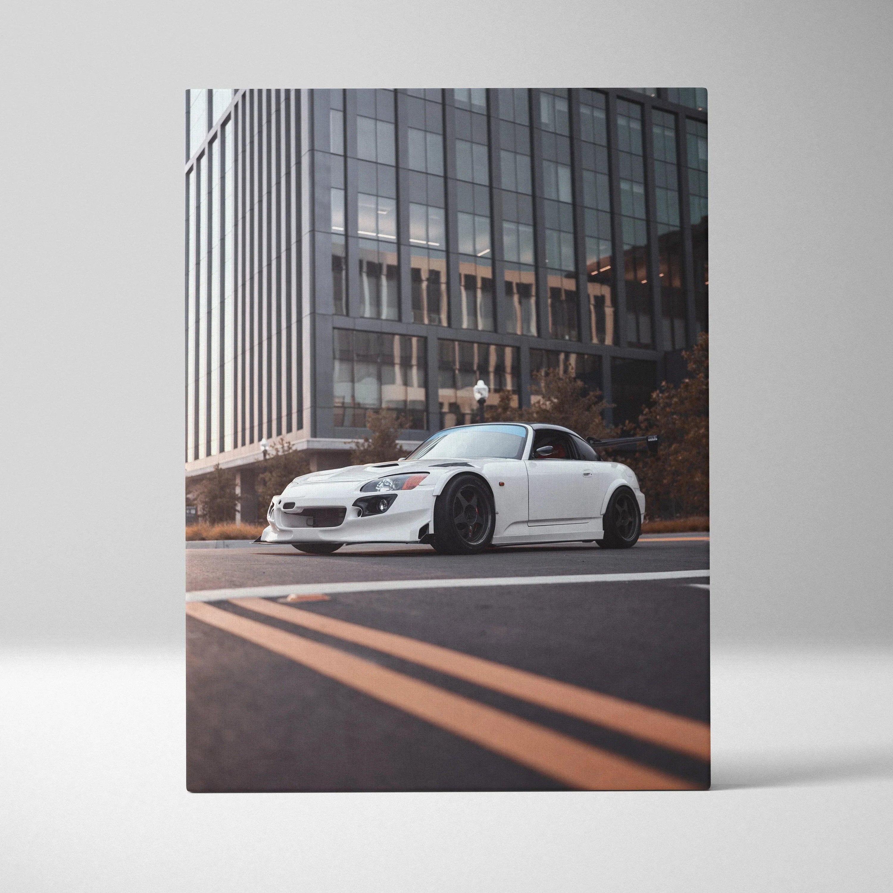 White Honda S2000 sports car on city street canvas wall art with modern building background.