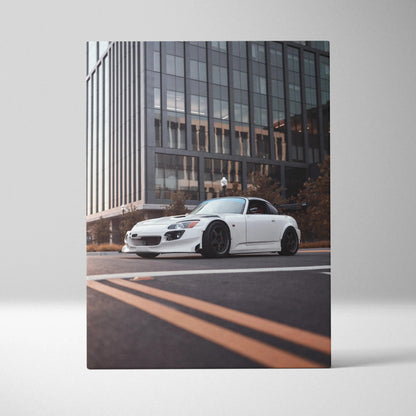 White Honda S2000 sports car on city street canvas wall art with modern building background.