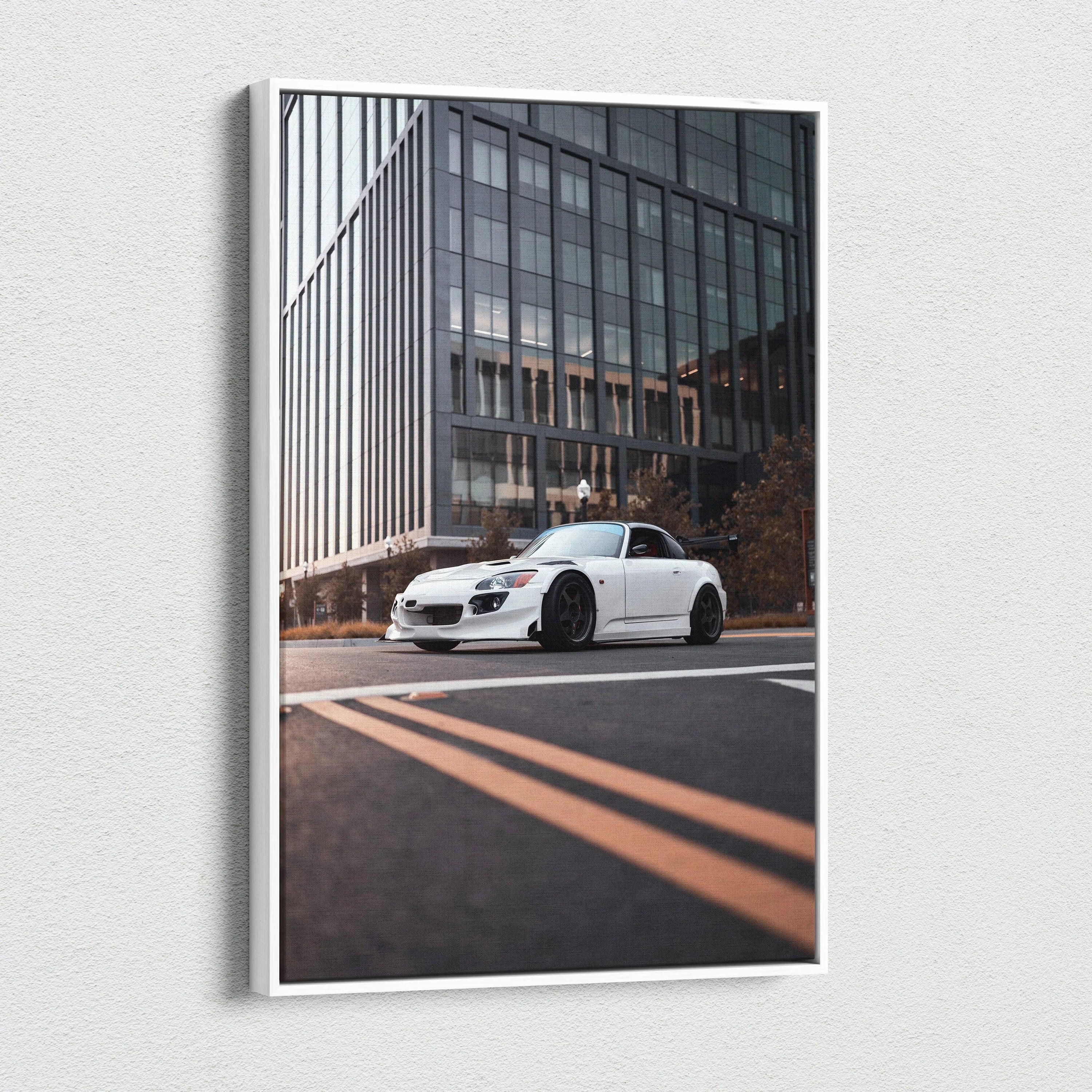 White Honda S2000 sports car on city street canvas wall art with modern glass building backdrop.