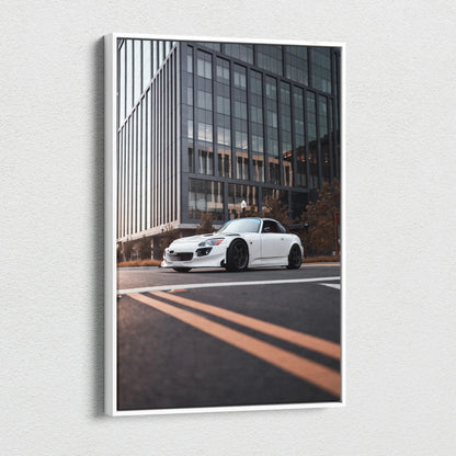 White Honda S2000 sports car on city street canvas wall art with modern glass building backdrop.