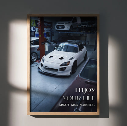 Motivational poster wall art featuring a white Honda S2000 with inspiring text in a garage setting.