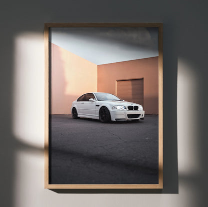 BMW E46 M3 in white parked against peach wall, modern automotive poster wall art.