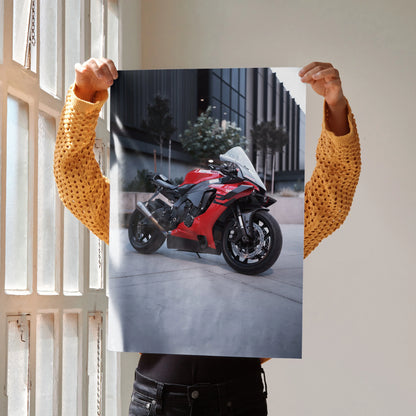 Yamaha R1 red motorcycle poster held indoors by person in mustard sweater, wall art design.