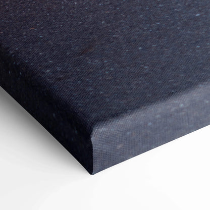 Close-up of black textured canvas edge showing museum quality vertical canvas art wrap.