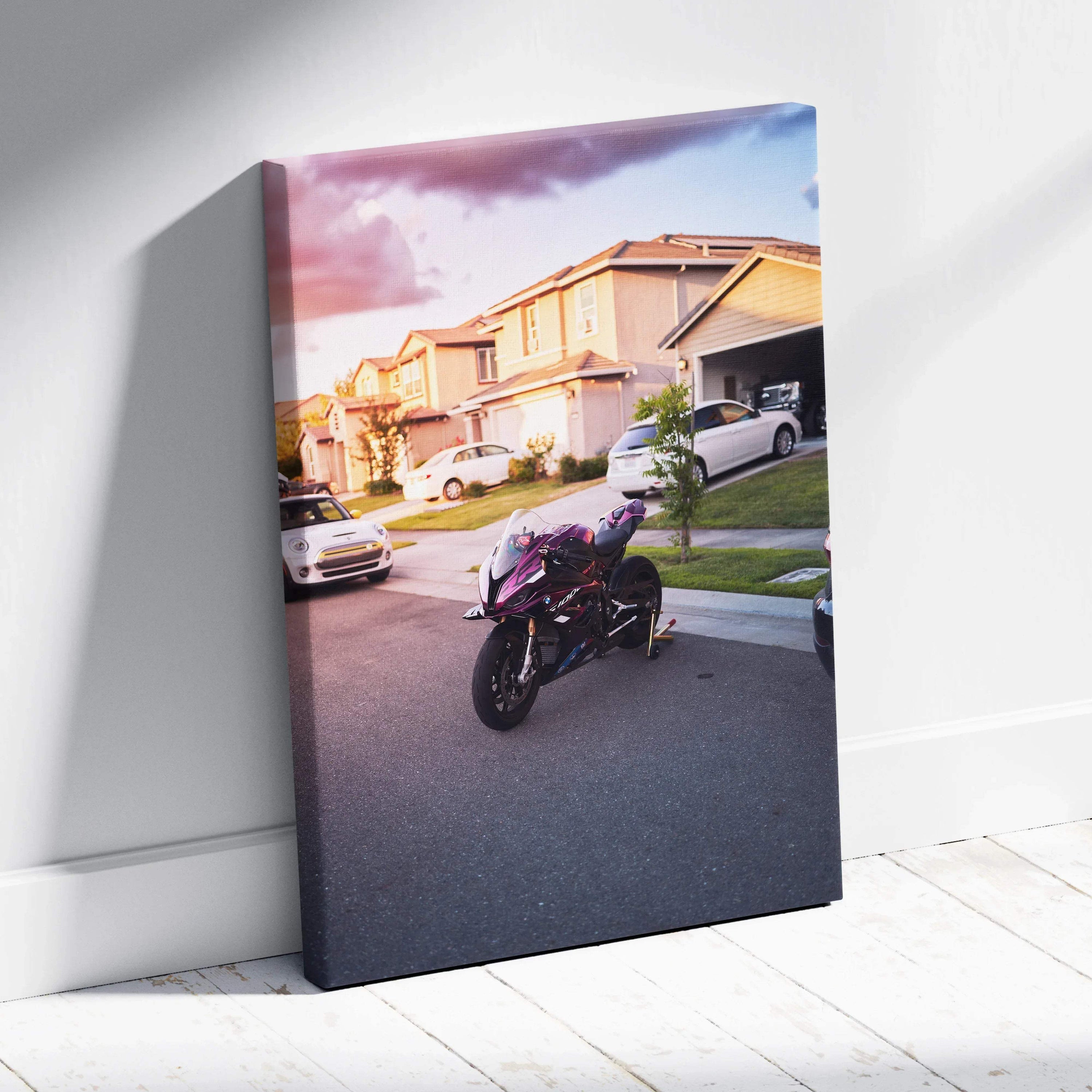Vertical canvas wall art featuring a BMW S1000RR motorcycle on a suburban street at sunset.