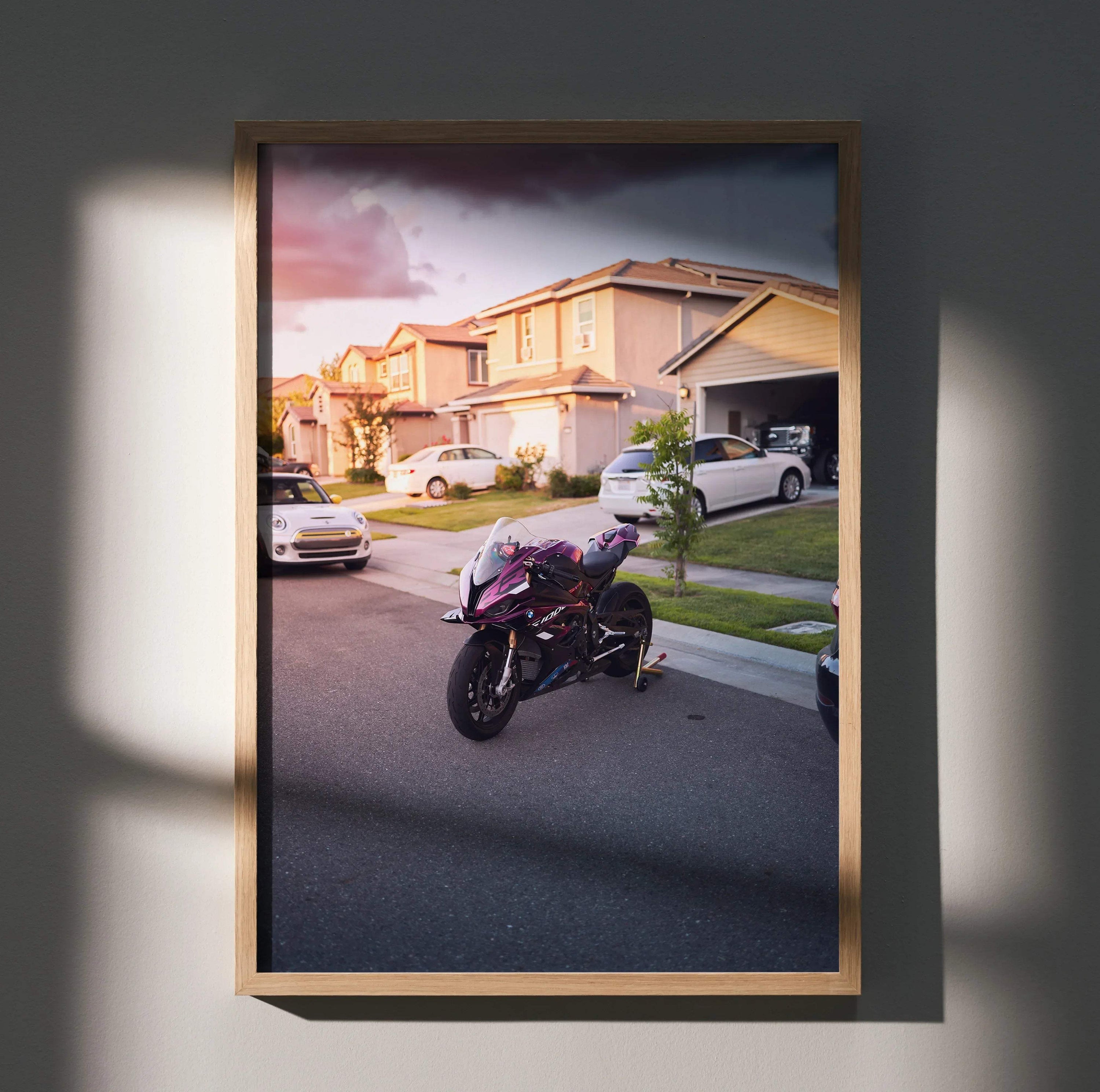 BMW S1000RR motorcycle parked on suburban street at sunset poster wall art in wooden frame.