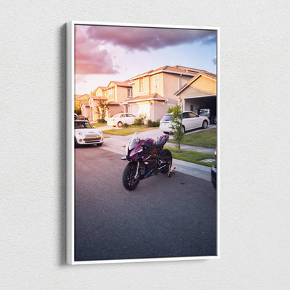 Vertical canvas wall art featuring a BMW S1000RR motorcycle parked on a suburban street at sunset.
