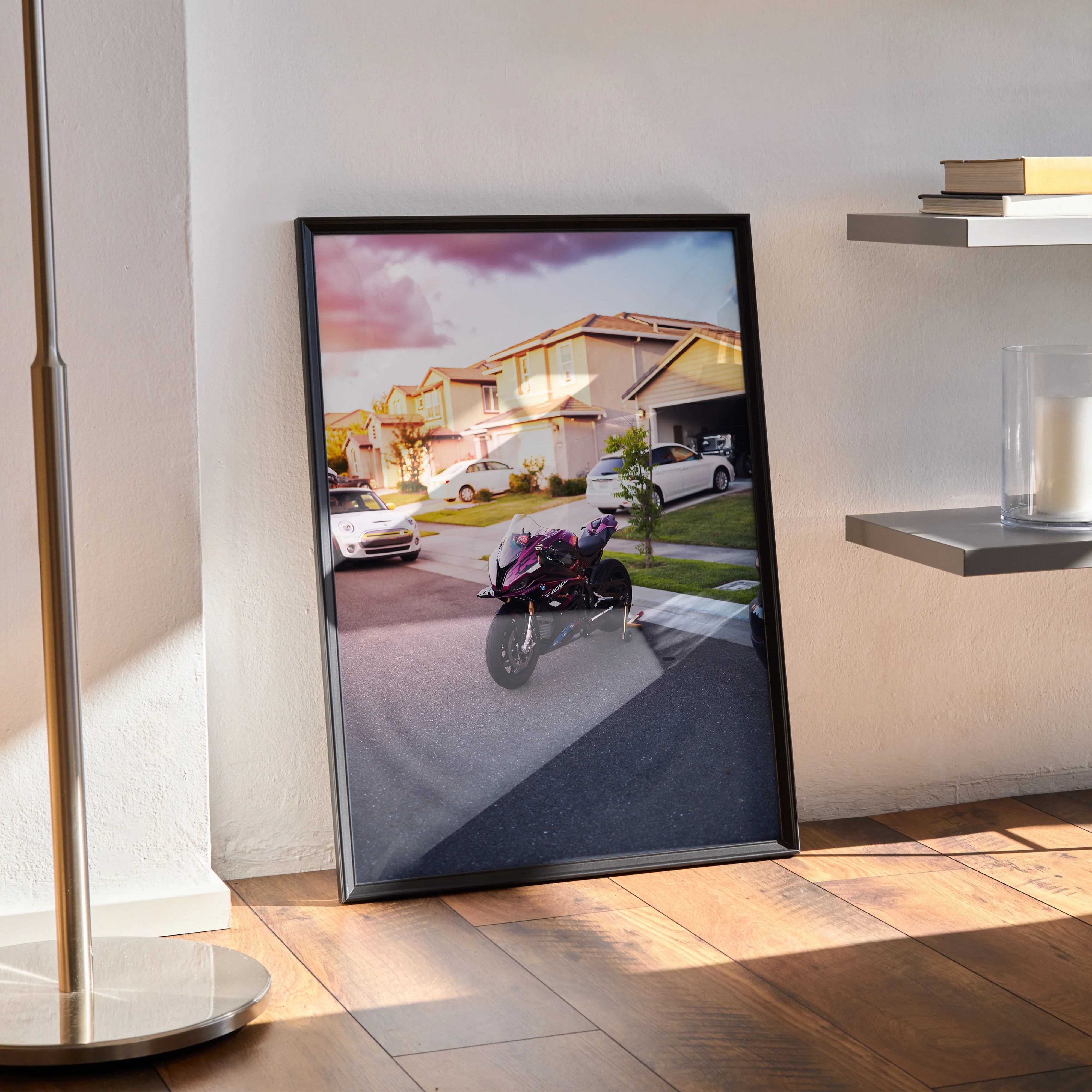 BMW S1000RR motorcycle poster with sunset background displayed as wall art in black frame.
