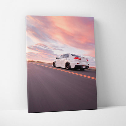 Mitsubishi Evo 10 driving on open road at sunset canvas wall art print with vibrant sky.
