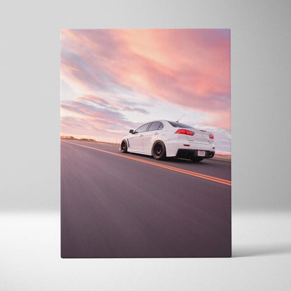 White Mitsubishi Evo 10 driving on road at sunset, vertical canvas wall art print.
