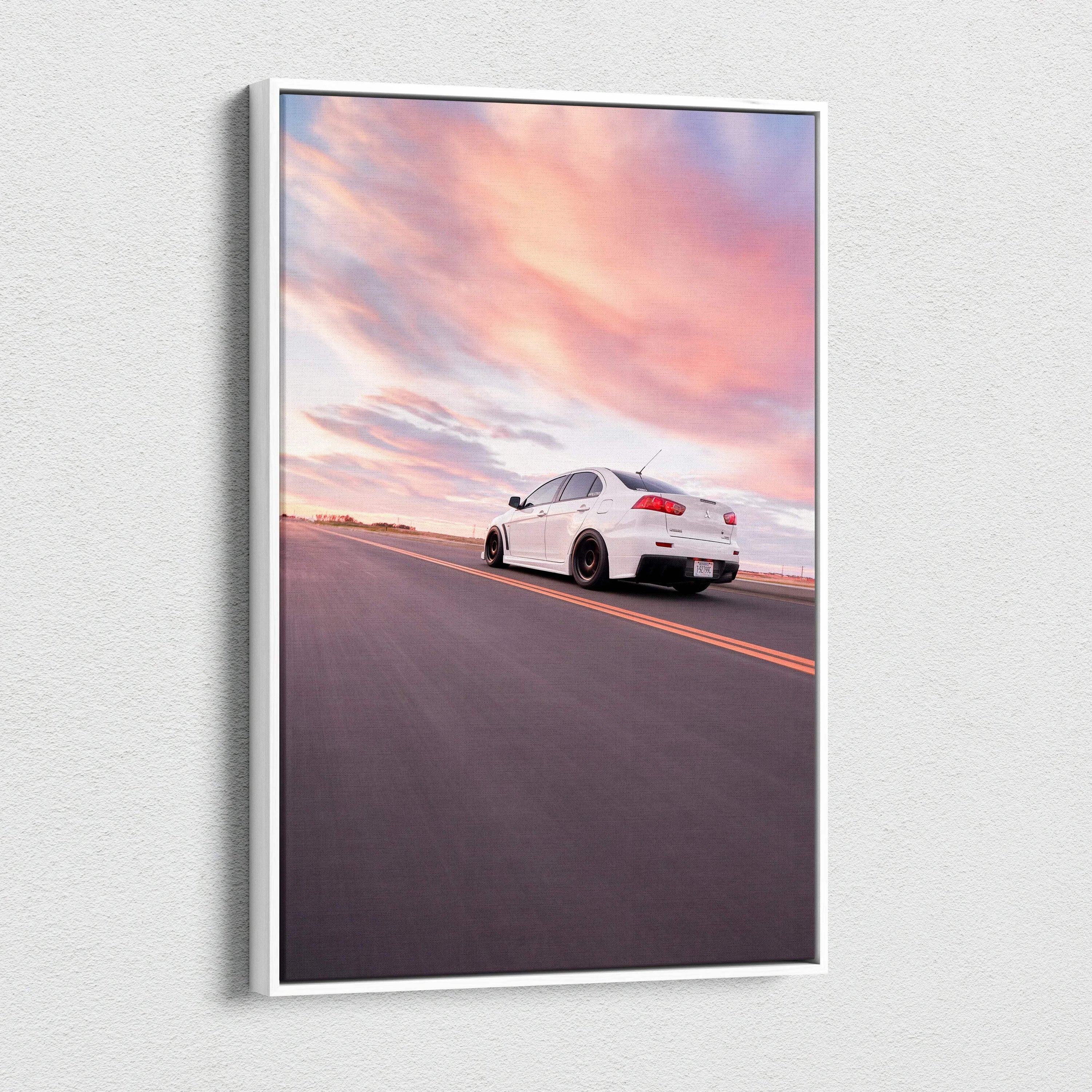 Vertical canvas wall art featuring a white Mitsubishi Evo 10 on an open road under a colorful sunset sky.