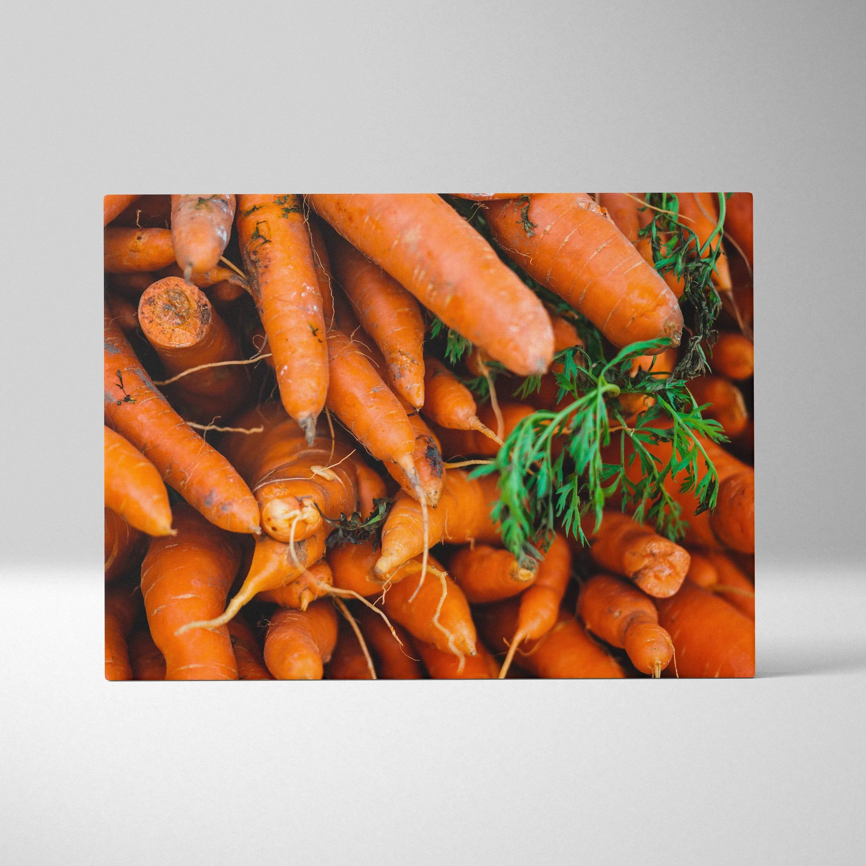 Canvas wall art featuring vibrant orange carrots with green leafy tops, detailed and colorful decor print.