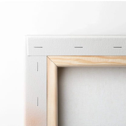 Close-up of white stretched canvas on wooden frame with metal staples for wall art decor.
