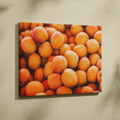 Vibrant canvas wall art featuring close-up of fresh juicy peaches in warm orange tones for home decor.