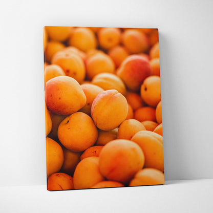 Vertical canvas wall art featuring a close-up of ripe peaches, vibrant colors for living room decor.