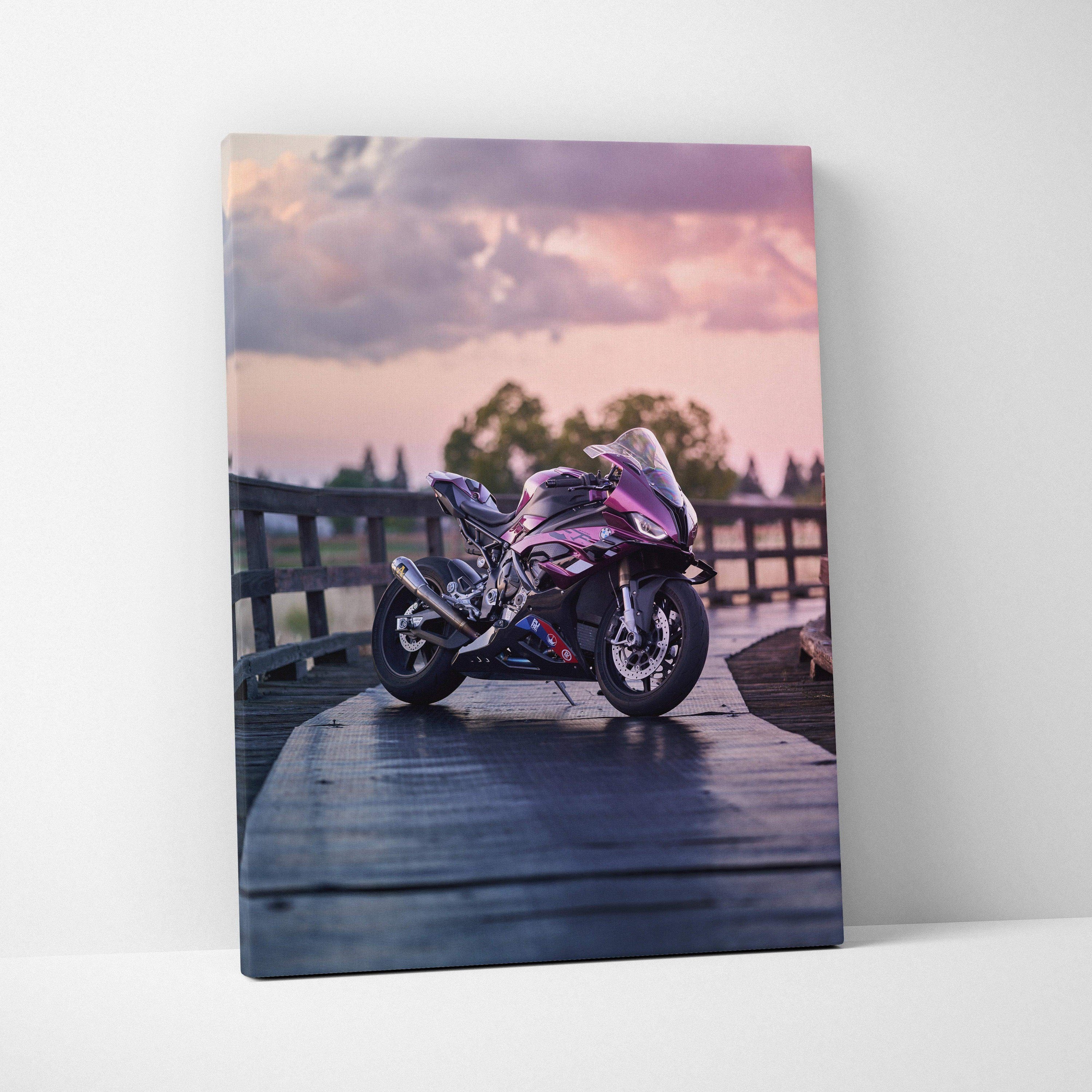 Vertical canvas wall art featuring a BMW S1000RR motorcycle on a wooden bridge at sunset.
