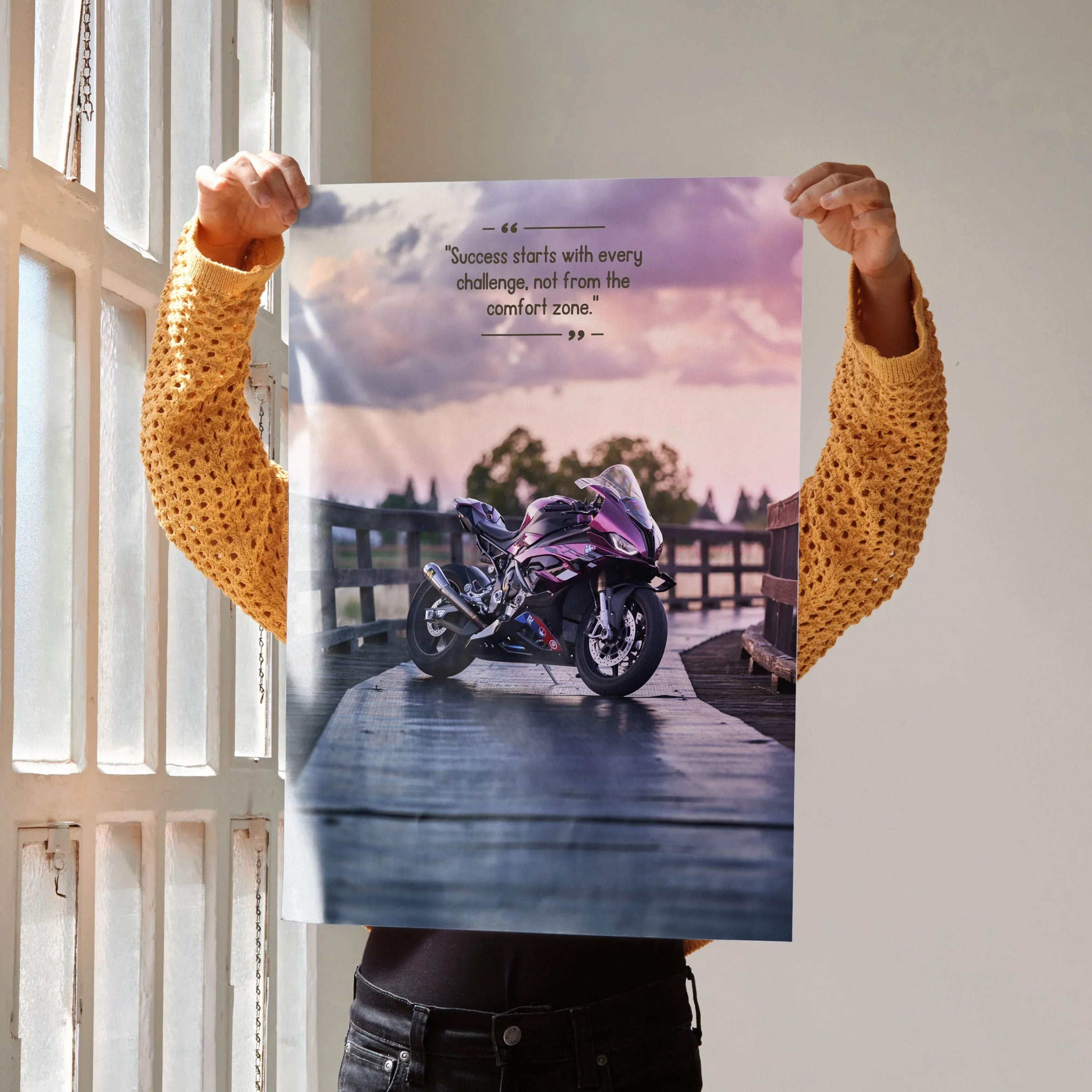 Motivational poster wall art featuring a BMW S1000RR motorcycle on a wooden deck with inspiring text and a pastel sunset sky.