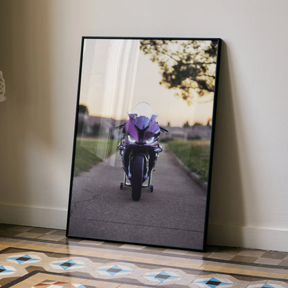 BMW S1000RR motorcycle poster with purple bike on road at sunset wall art in black frame.