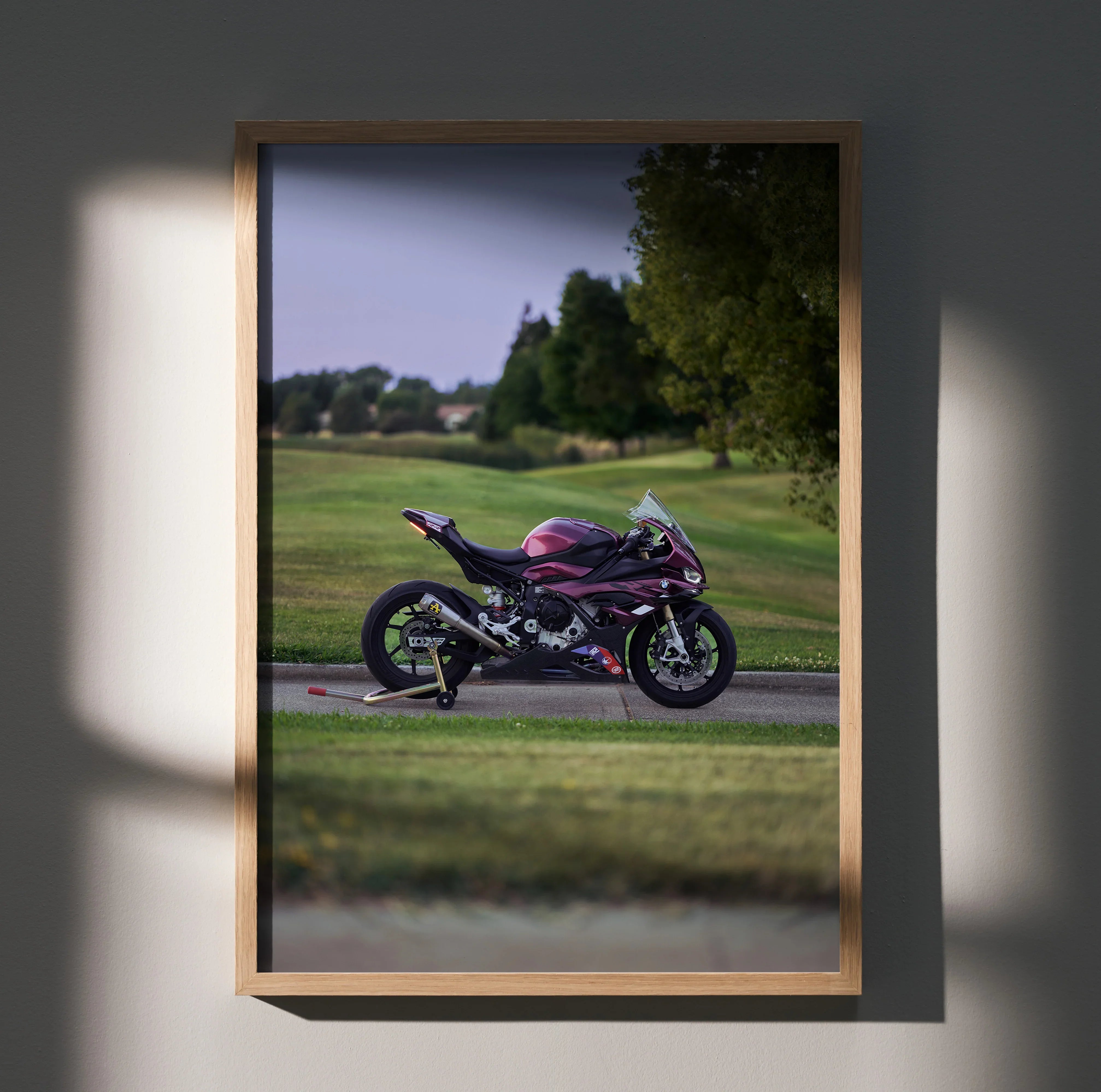 BMW S1000RR motorcycle poster wall art featuring a purple bike on a racetrack with green landscape background.