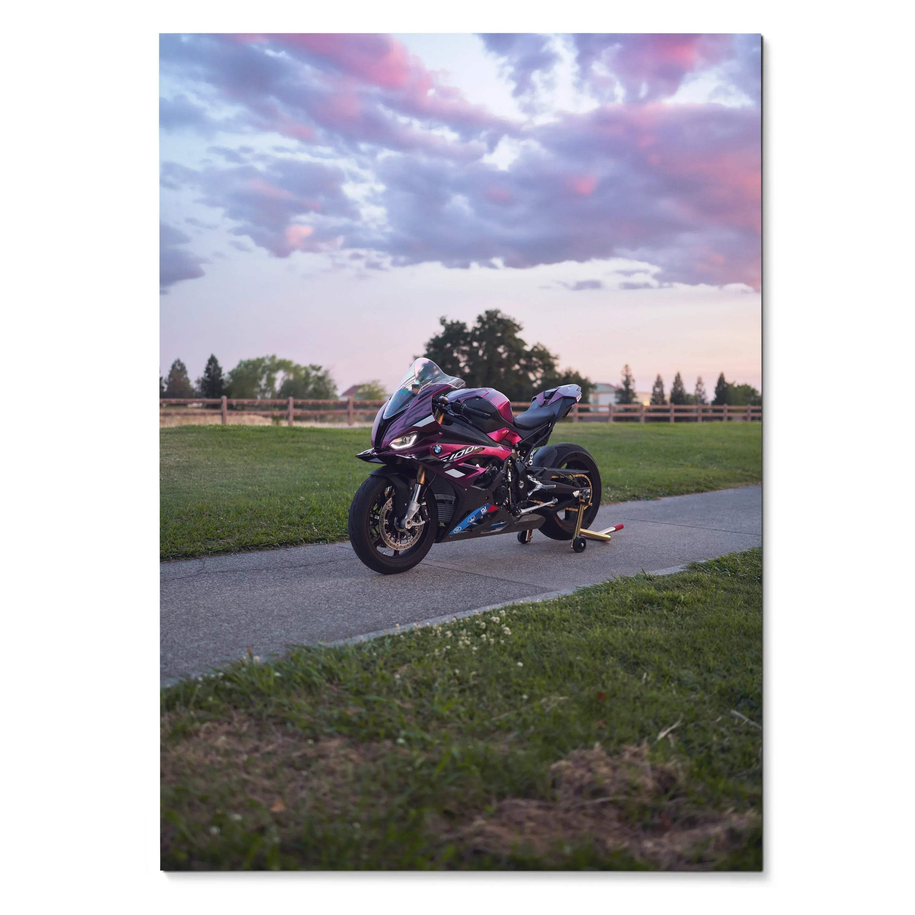 BMW S1000RR motorcycle parked on pathway during sunset Poster Wall Art with colorful sky background.