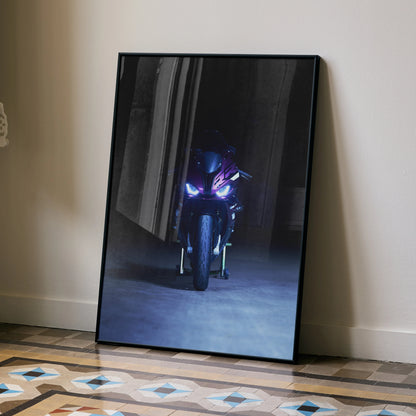 Black-framed poster featuring BMW S1000RR motorcycle with headlights on in dark setting, wall art design.