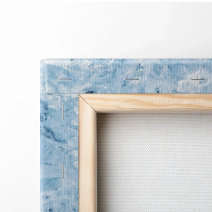 Close-up of stretched canvas art with blue swirling colors and wooden frame for wall art.