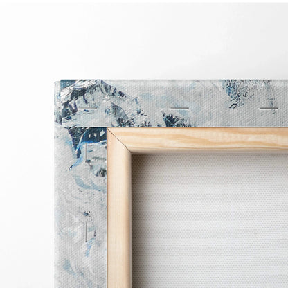 Corner of a stretched canvas print with abstract blue and gray digital art on natural wood frame.