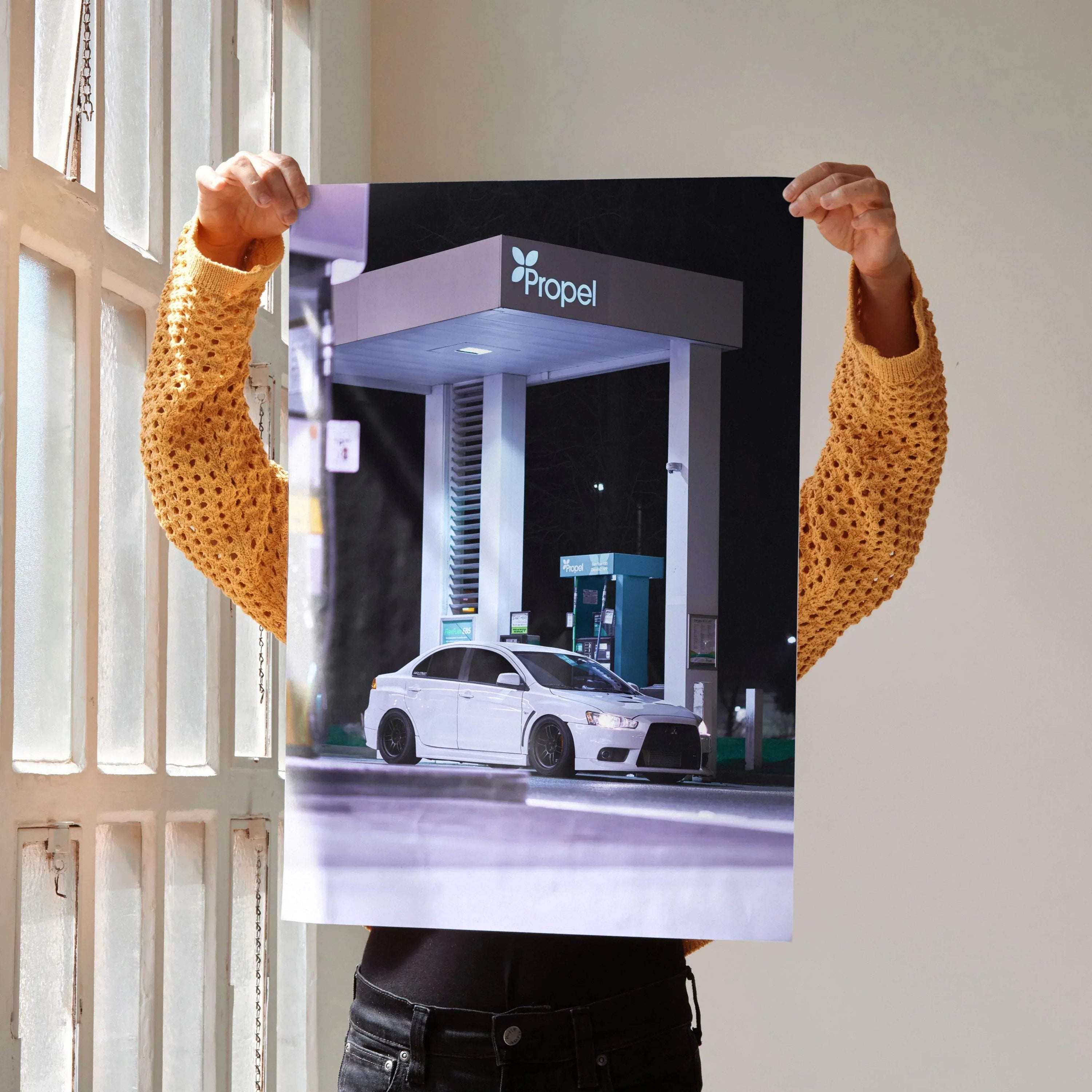 Mitsubishi Evo 10 white sports car at gas station poster wall art.