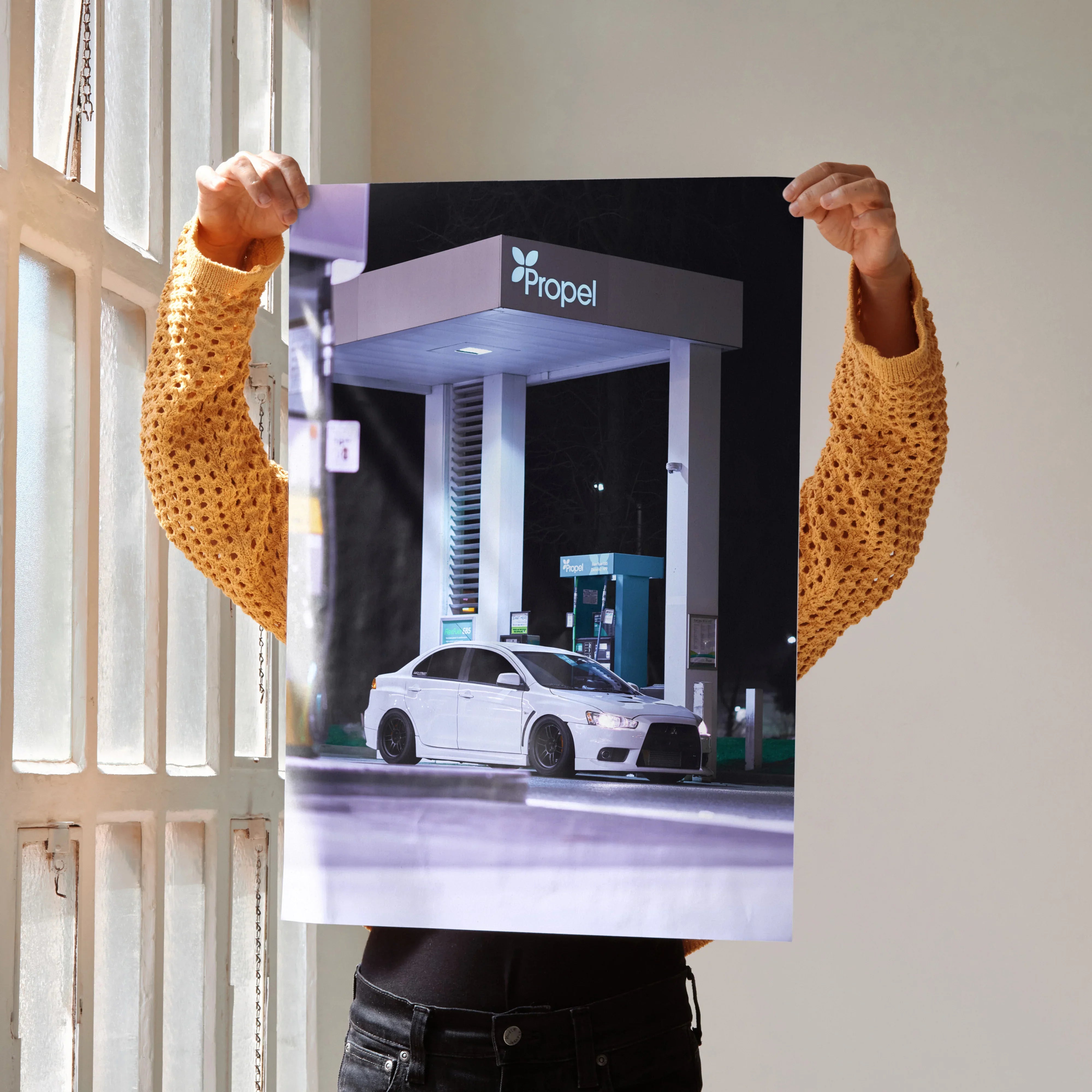 Mitsubishi Evo 10 white sports car at gas station poster wall art.