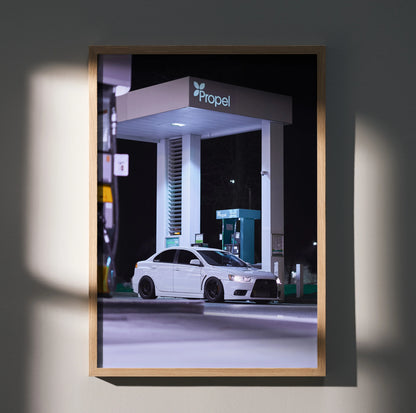 Mitsubishi Evo 10 poster wall art featuring a white car parked under a lit gas station canopy at night.