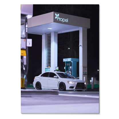 Mitsubishi Evo 10 white sports car parked at illuminated night gas station poster wall art.