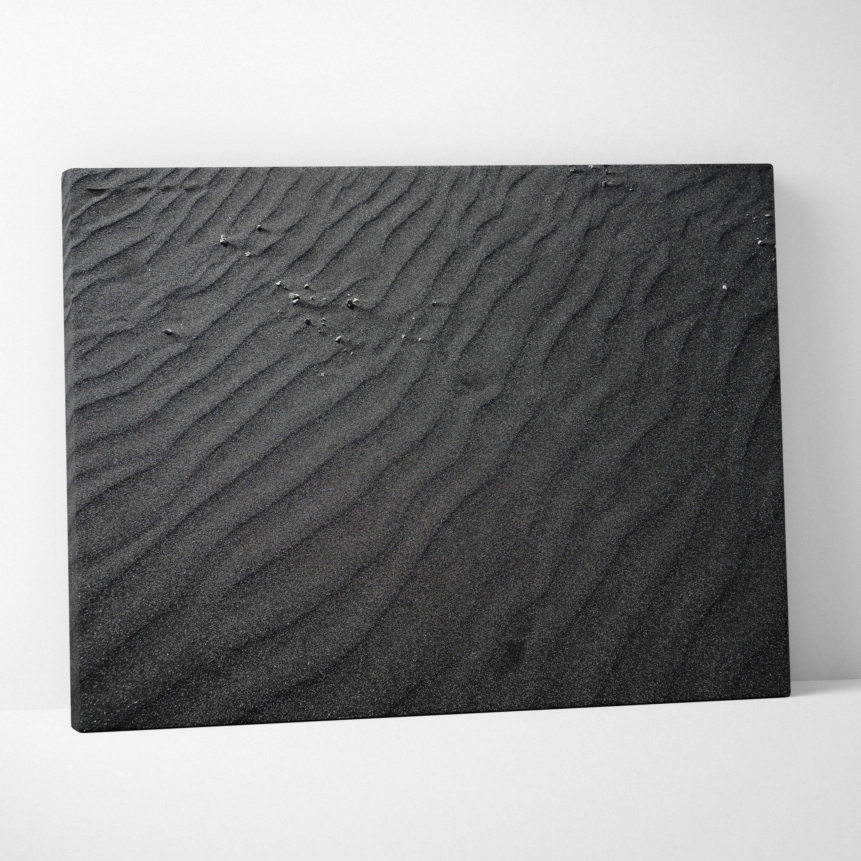 Black abstract digital art canvas with textured ripple patterns mimicking sand dunes.