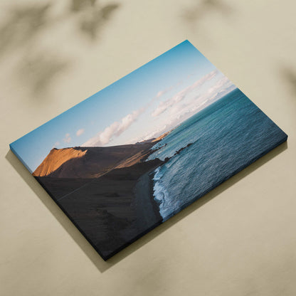 Canvas print of Iceland coastline with dark volcanic sand, turquoise waves, golden cliffs