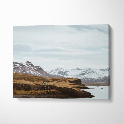 Canvas print of Nordic Icelandic snowy mountain coastline with cabin
