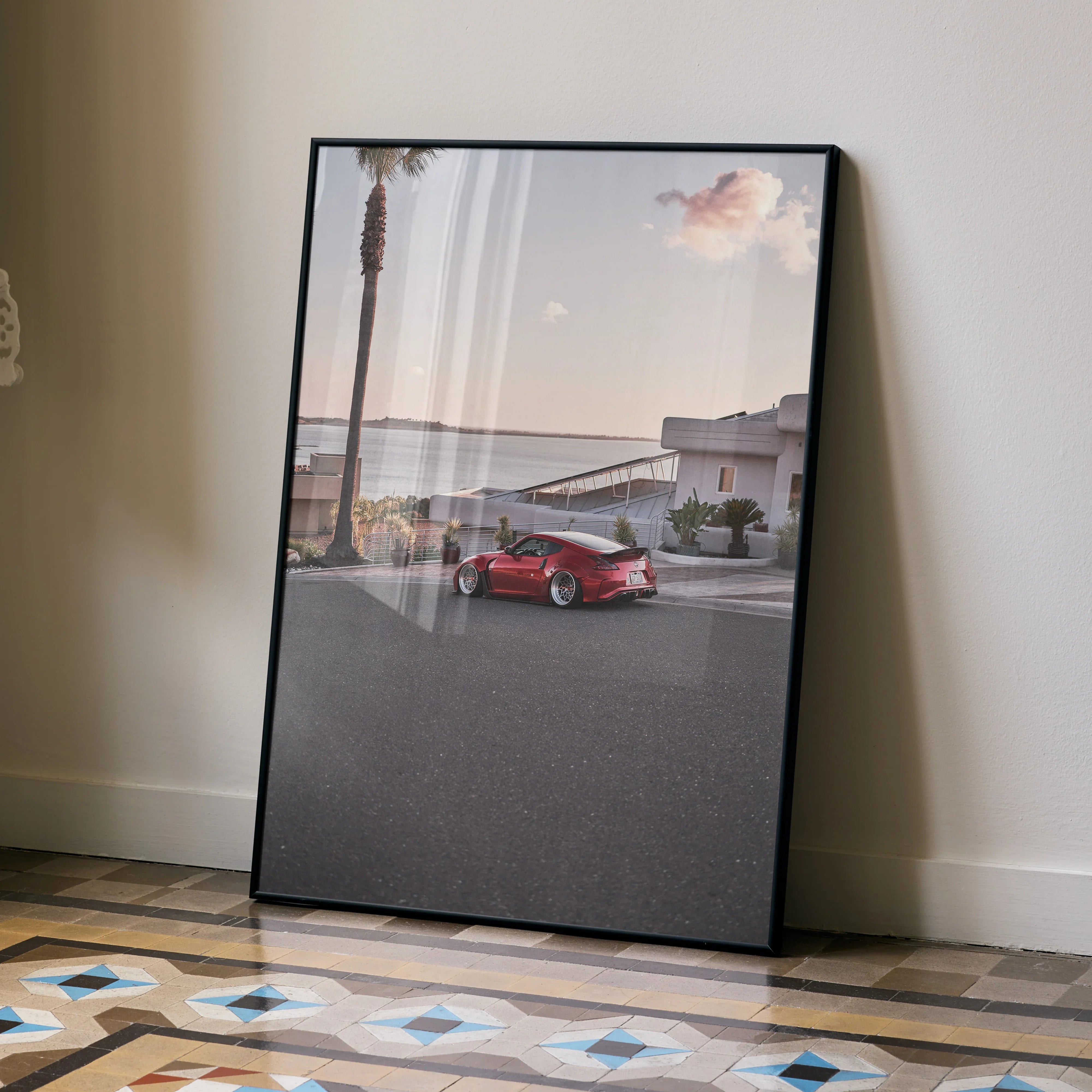 Nissan 370z parked on coastal road poster wall art with palm trees and pastel sky.