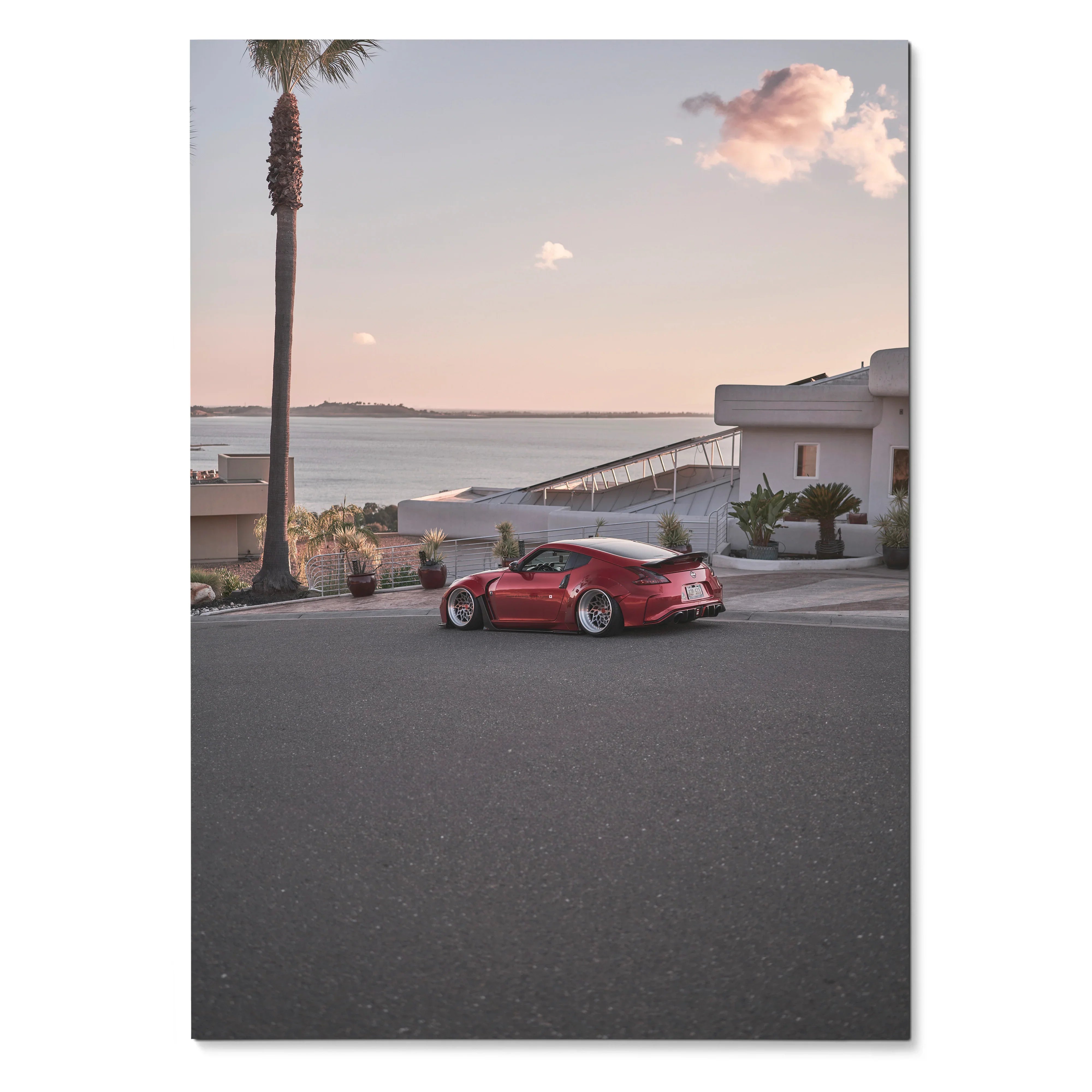 Nissan 370z red sports car parked on coastal street at sunset poster wall art.