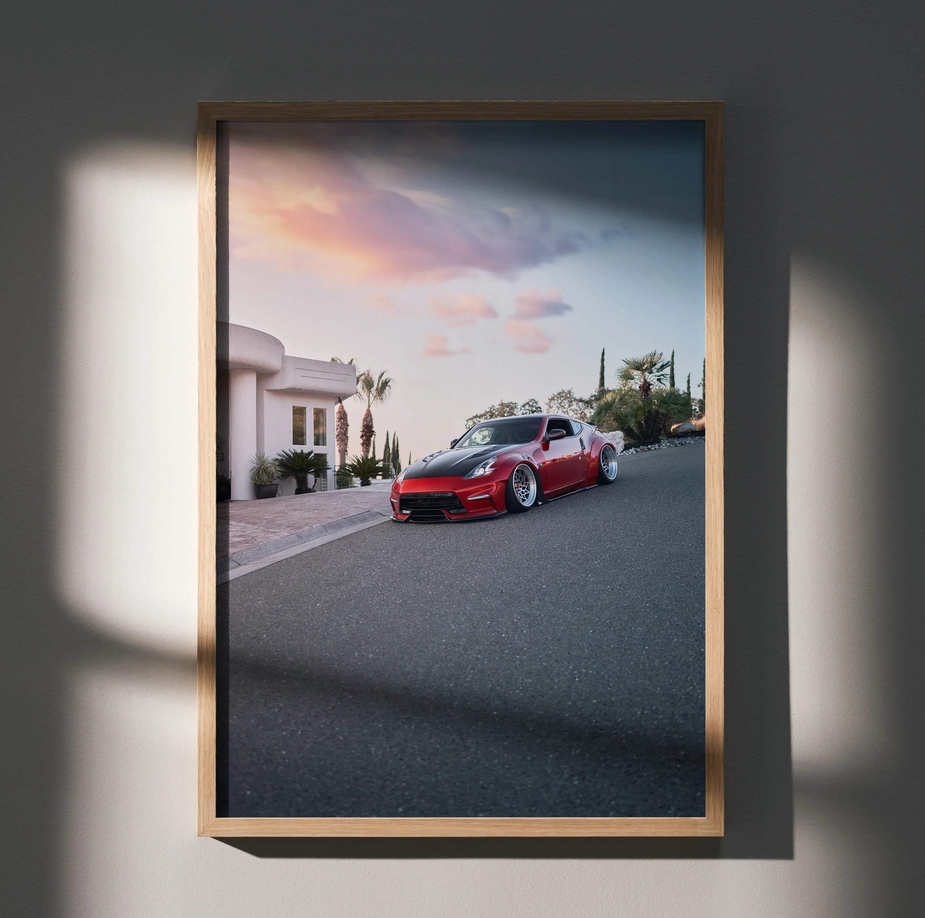 Nissan 370z red sports car on sunset street poster wall art in wooden frame.