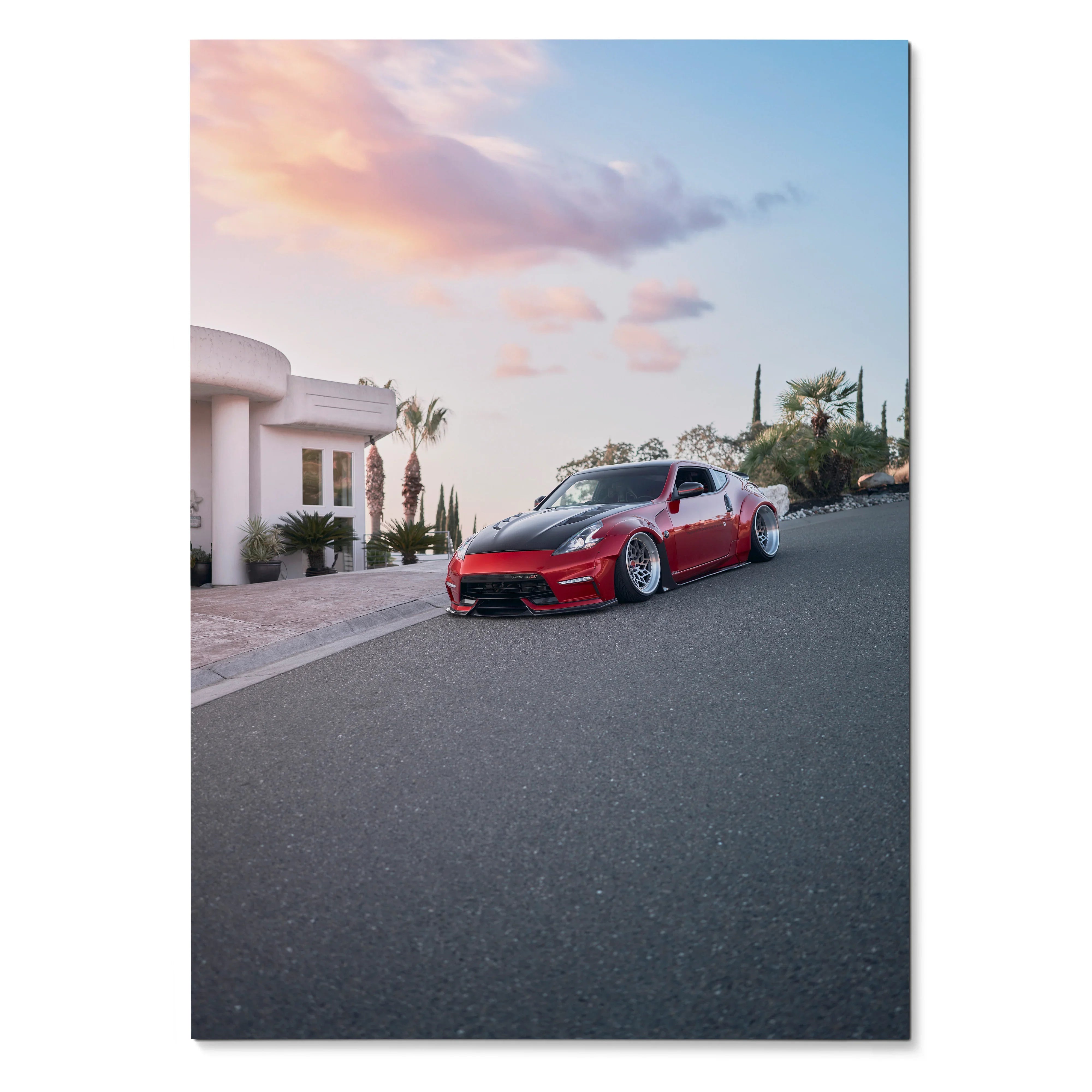 Nissan 370z parked on street during sunset Poster wall art with vibrant sky and sleek car body.