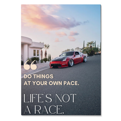 Motivational poster wall art featuring red Nissan 370z on road with sunset sky and inspiring text.