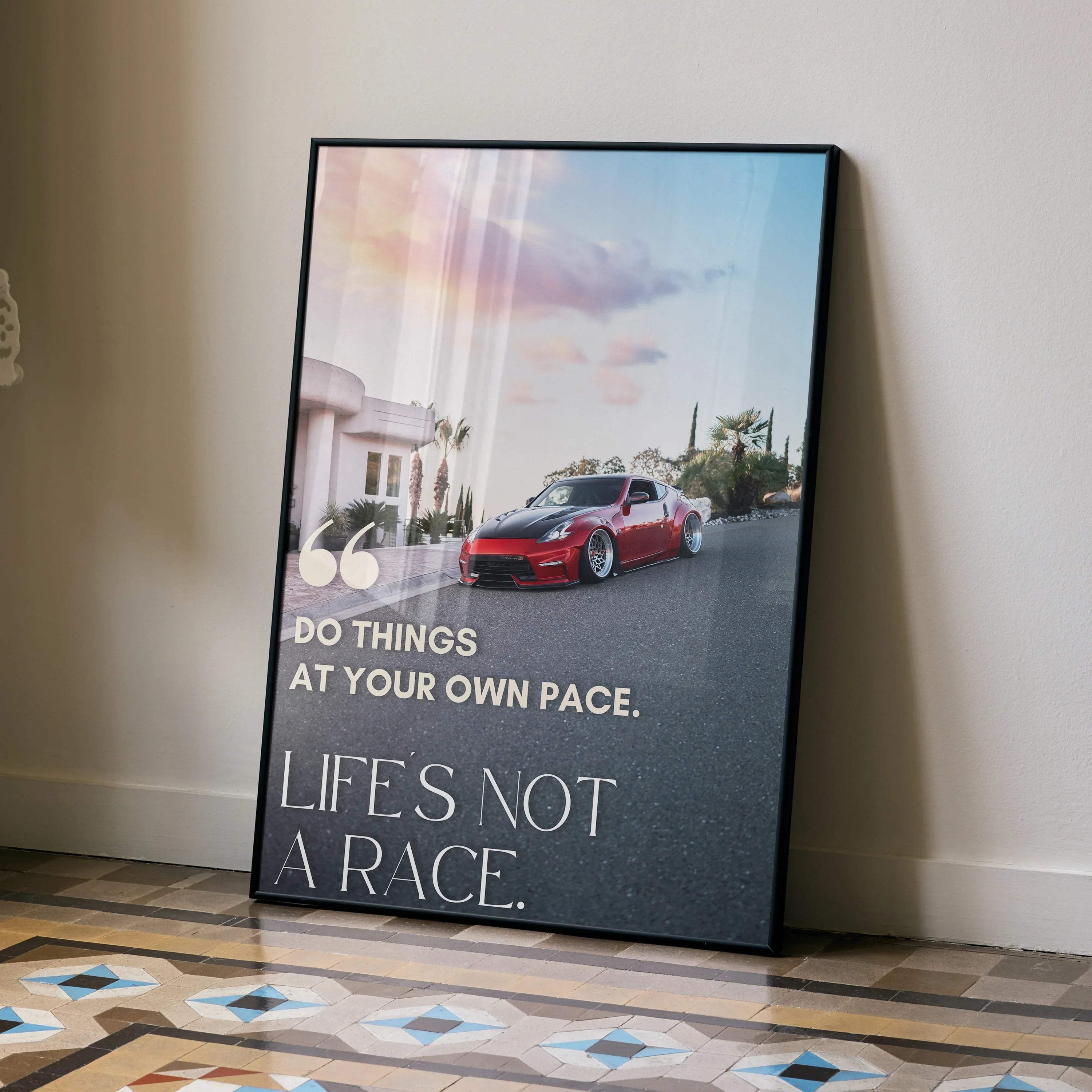 Motivational poster wall art featuring red Nissan 370z on road with inspiring text about life and pace.