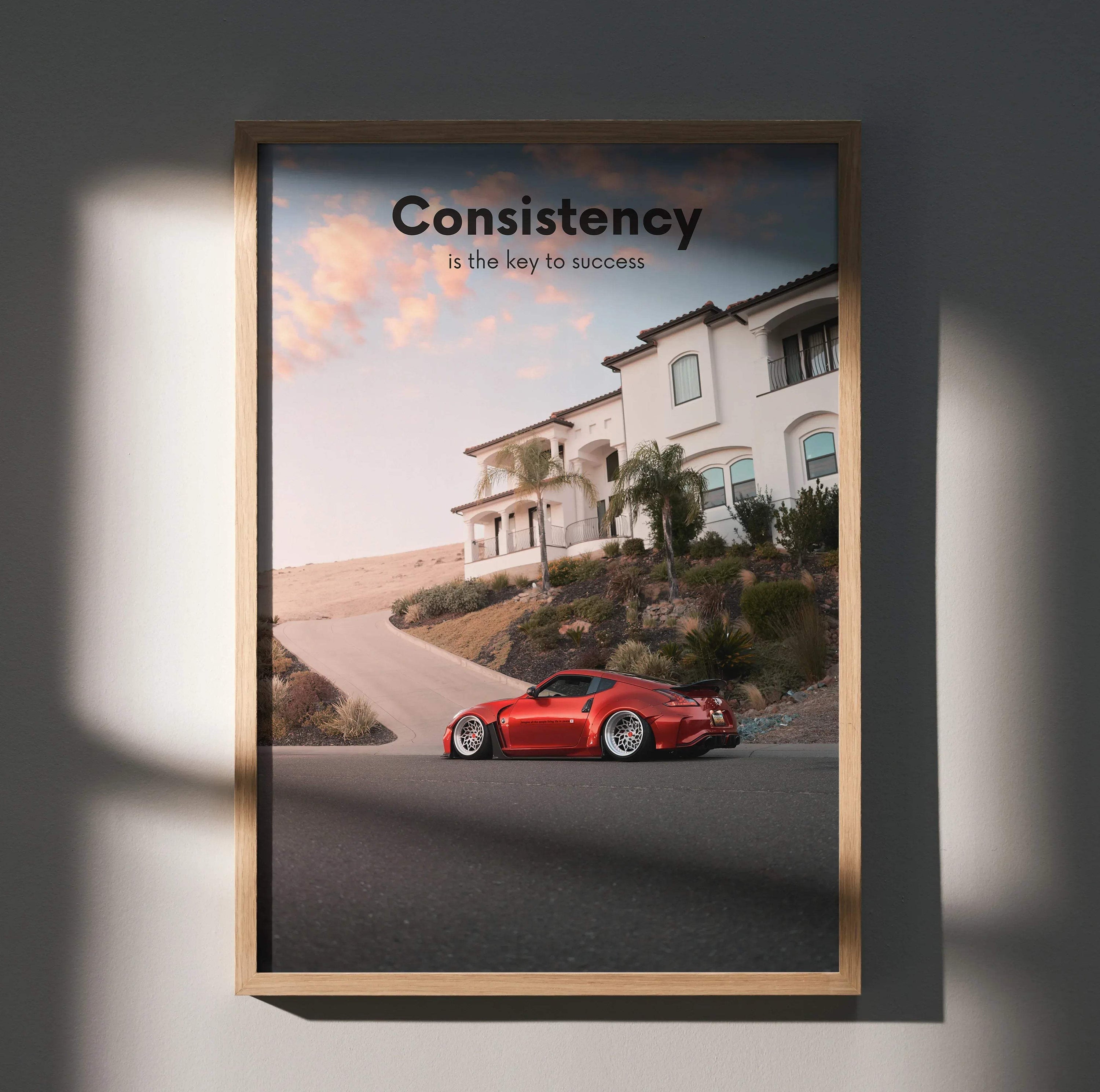 Motivational poster wall art featuring a red Nissan 370z on a residential street with inspiring text "Consistency is the key .