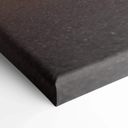 Close-up of black textured canvas stretched over wooden frame for wall art.