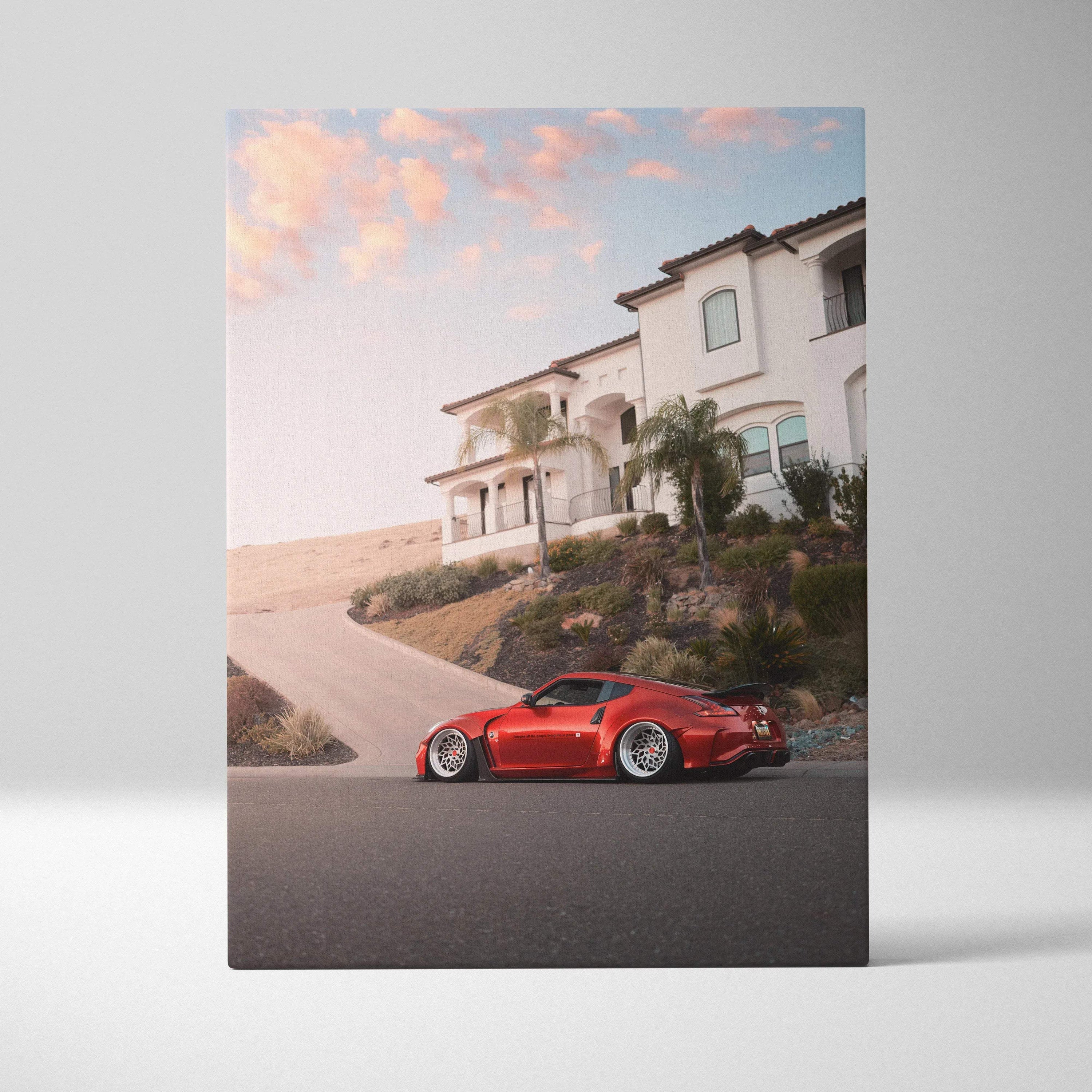 Red Nissan 370z parked in front of modern house at sunset vertical canvas wall art.