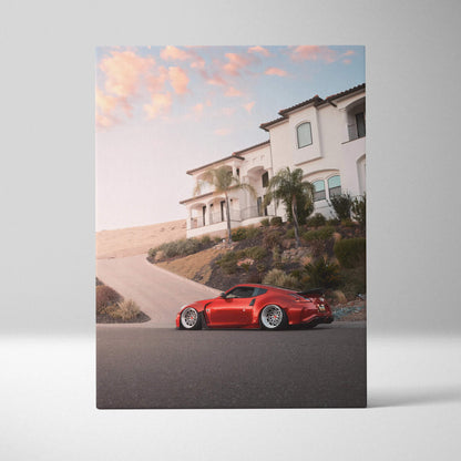 Red Nissan 370z parked in front of modern house at sunset vertical canvas wall art.