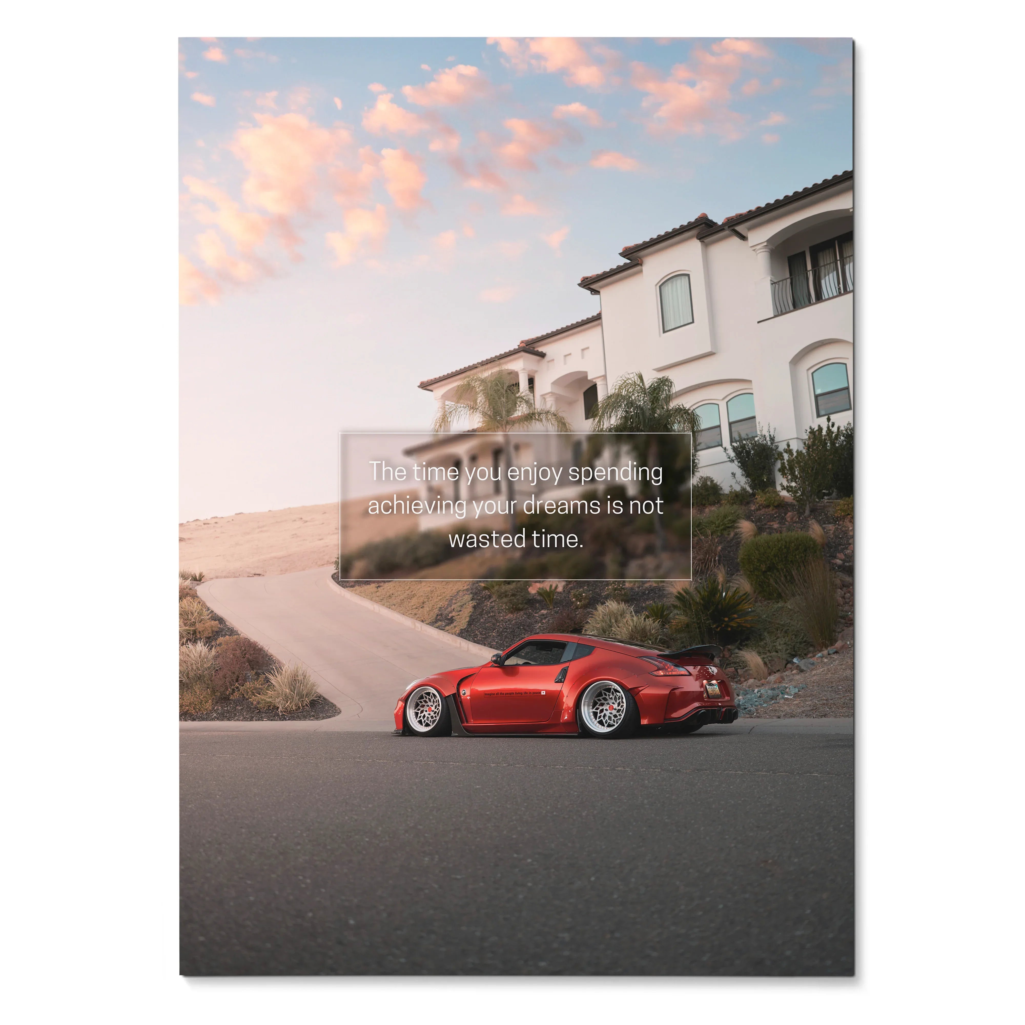 Nissan 370z red sports car parked on curved road with motivational quote poster wall art.