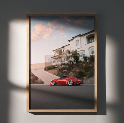 Motivational wall art poster featuring a red Nissan 370z parked on a street with a scenic sunset sky.