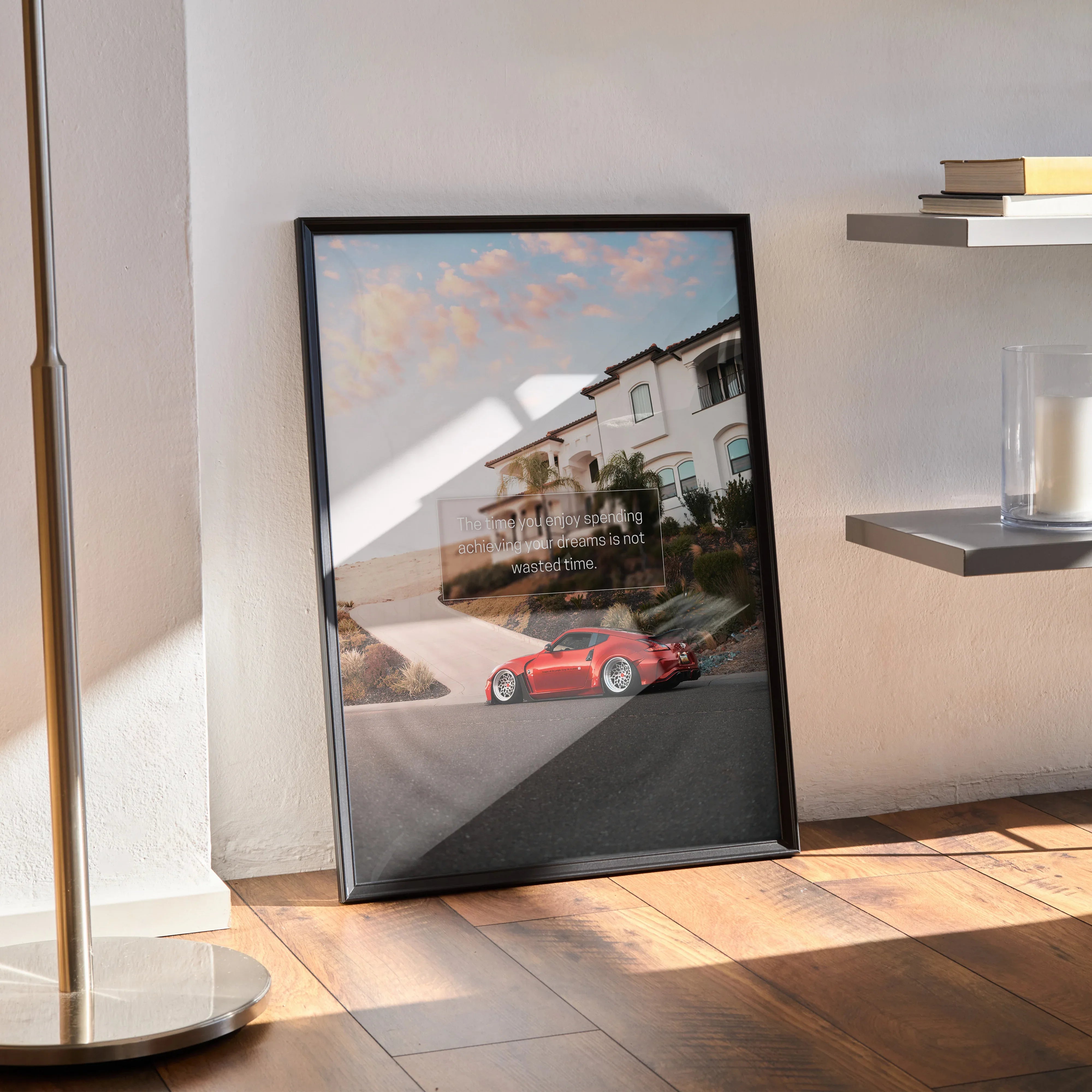 Motivational poster wall art featuring red Nissan 370z on coastal road with inspiring quote in black frame.