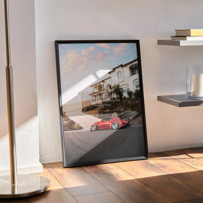 Motivational poster wall art featuring red Nissan 370z on coastal road with inspiring quote in black frame.