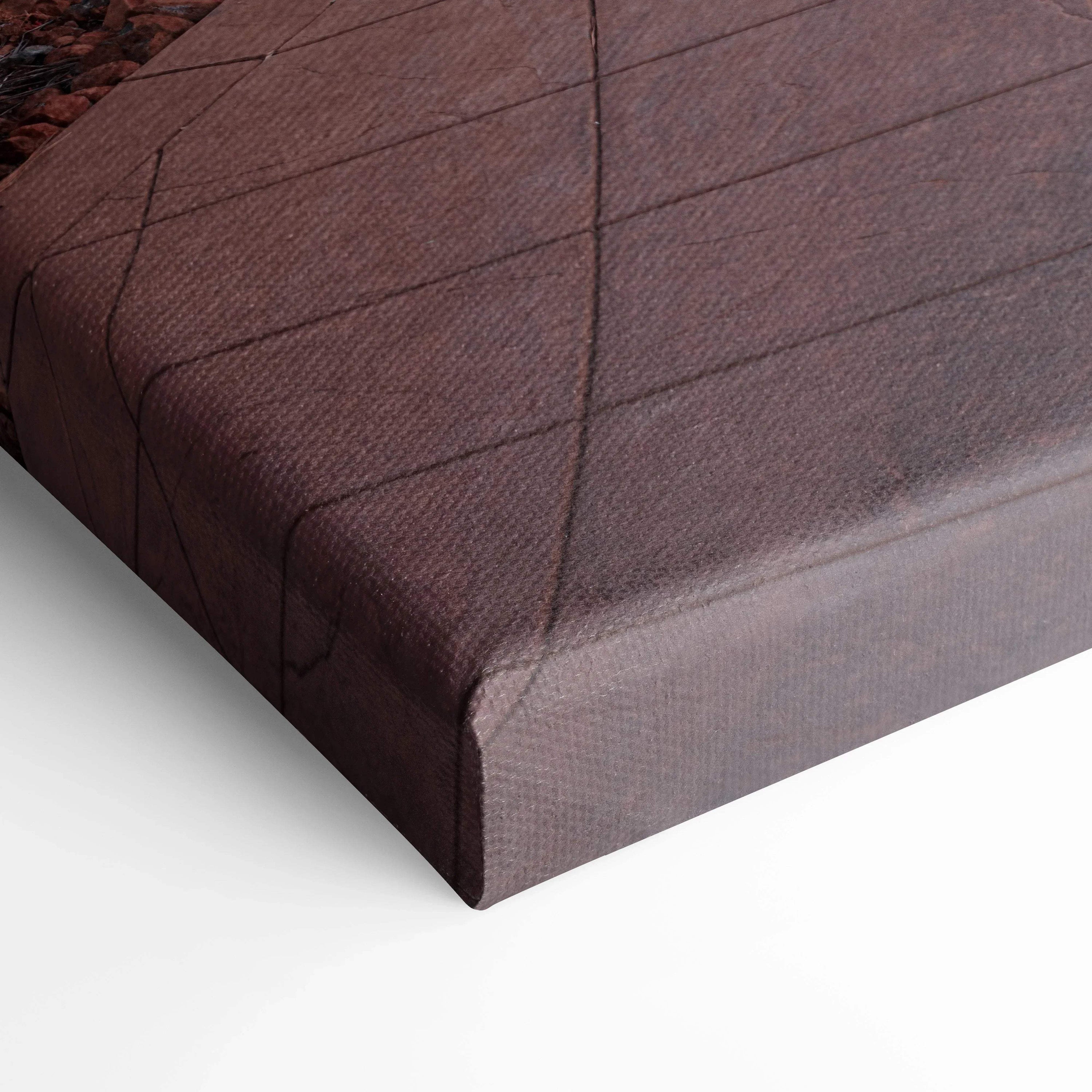 Close-up of textured canvas wrap corner in dark muted colors for wall art display.